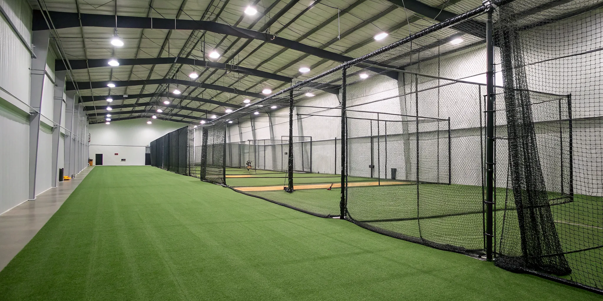 Commercial batting cage for sale with multiple indoor hitting tunnels.